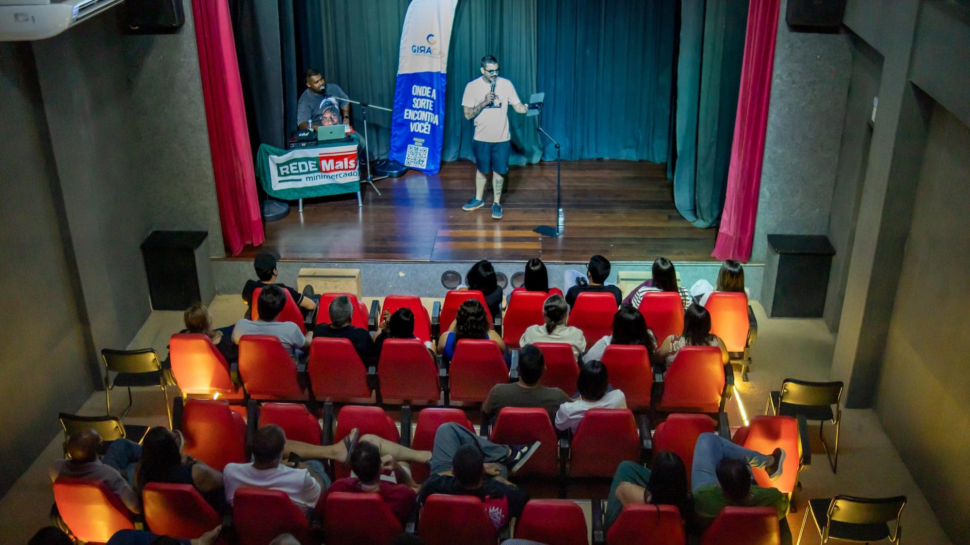 Outro ângulo do palco, com Igor em cena e a plateia em primeiro plano